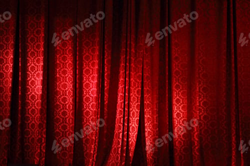 Preview: Closed red curtain in the theater.