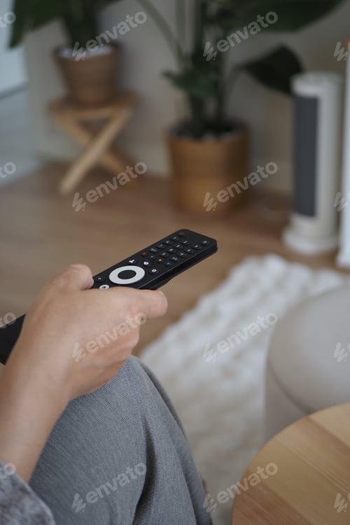 Preview: Watching TV in a living room with a remote control