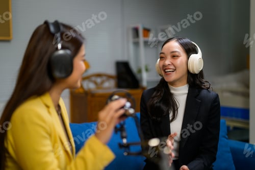 Preview: Young Asian women recording podcast interview with headphones