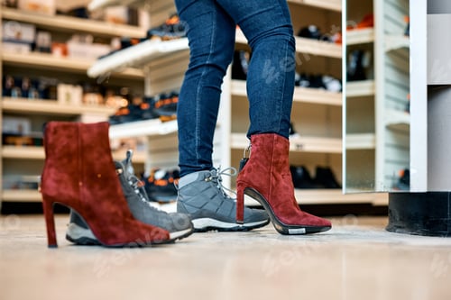 Preview: Close up of woman buying new pair of shoes at shopping mall.