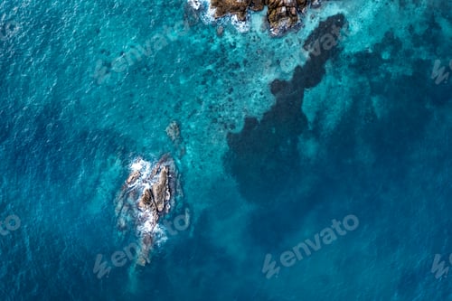 Preview: Blue sea and rocks on the island form above