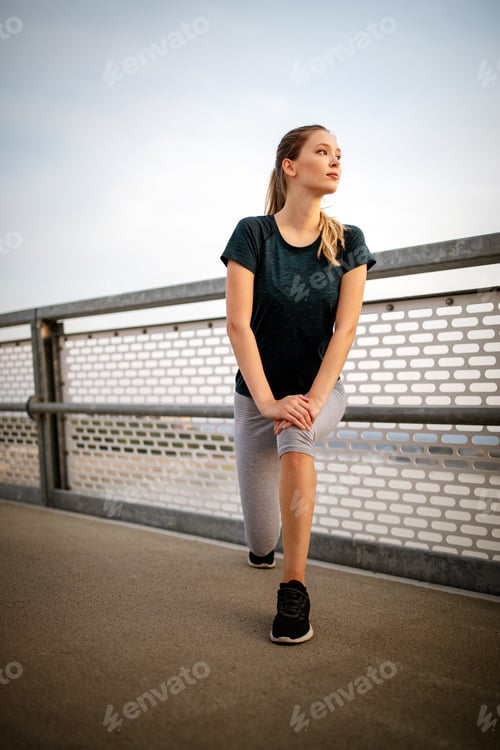 Preview: Portrait of fit and sporty young woman doing stretching in city