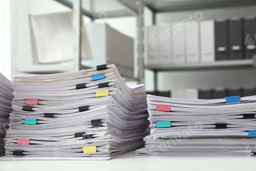 Preview: Stacks of documents with paper clips on office desk