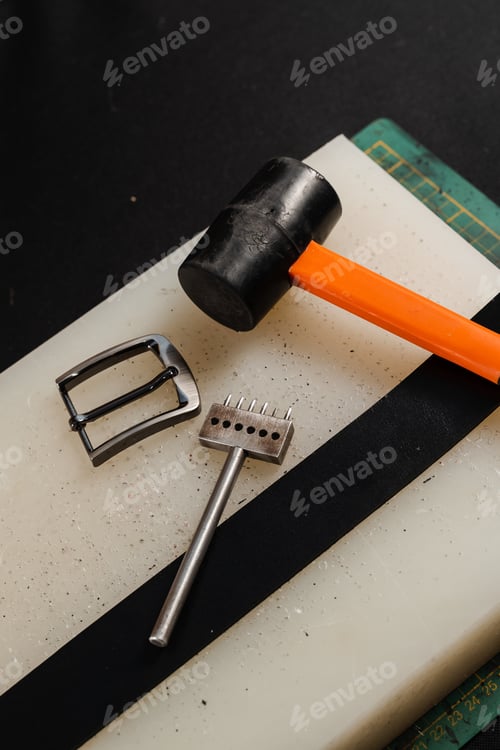 Preview: Genuine leather belt tools set with buckle, hammer and punch on workbench