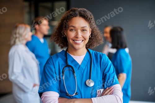 Preview: Smiling Woman Doctor in Blue Uniform With Colleagues