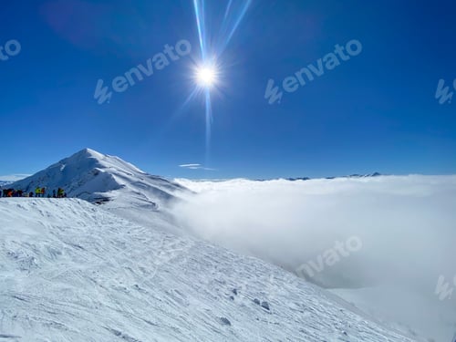 Preview: A beautiful view to the skiing mountains and a fog around on a sunny day
