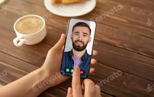 Preview: Cropped of woman having video conference with bearded man