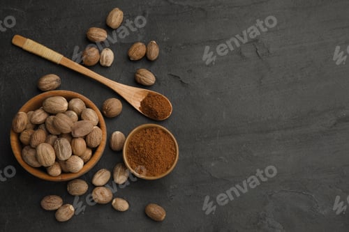 Preview: Nutmeg powder and seeds on black table, flat lay. Space for text