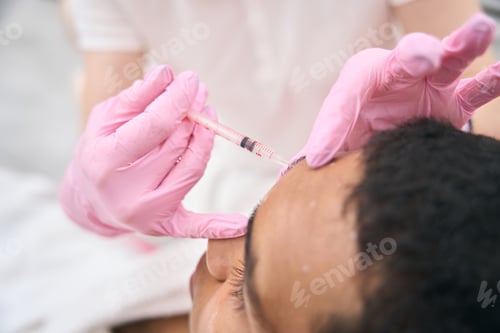 Preview: Esthetic medicine clinic client receiving dermal filler injection into forehead