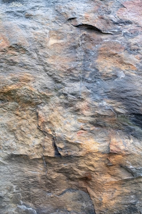 Preview: Multicolored rock wall. Stone textured surface close-up. Copy space. Abstract natural background.