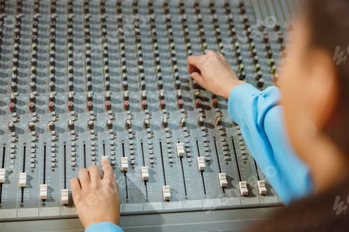 Preview: Producer working in music recording studio, using mixing board, software to create new song