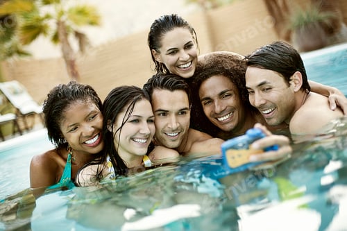 Preview: A group of young men and women in the swimming pool at the end of a hot day, posing for a selfy.