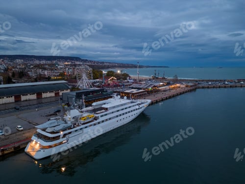 Preview: aerial view of luxury yacht in port at night