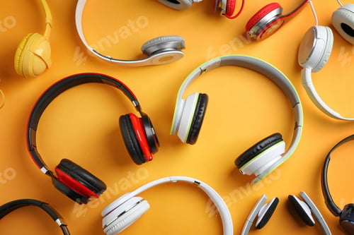 Preview: Many different headphones on color background, top view