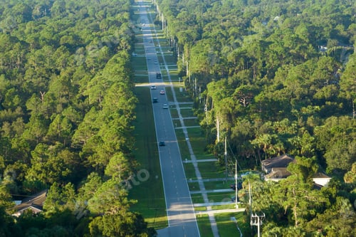 Preview: Aerial view of street traffic with driving cars in small town.