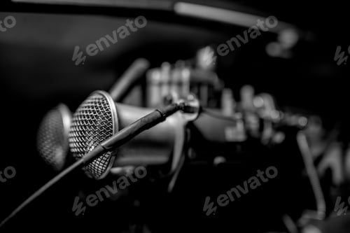 Preview: Grayscale shallow focus of a microphone with a black background