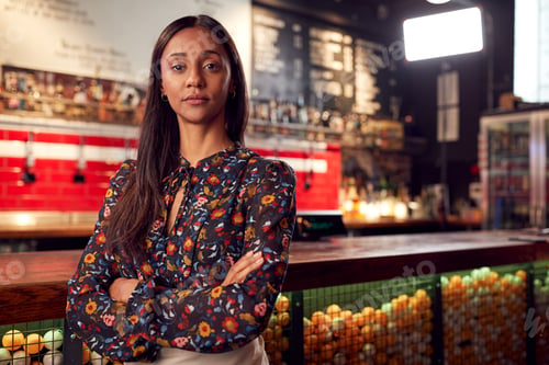 Portrait Of Female Bar Owner Standing By Counter