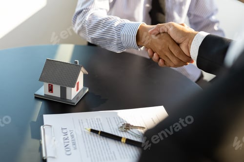 Preview: Real estate agents businessmen shake hands after the signing of the contract agreement is complete.