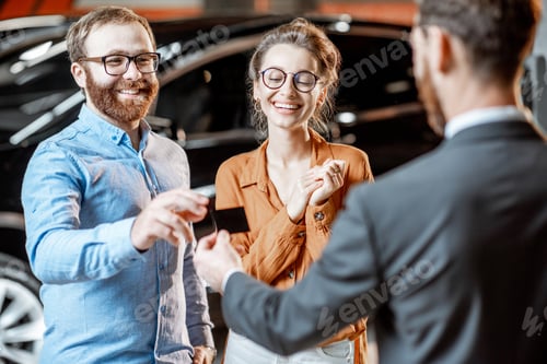 Preview: Couple with a seller at the car dealership