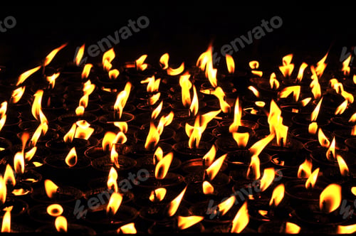 Preview: Butter lamps with flames near Bodhnath stupa in Kathmandu, Nepal