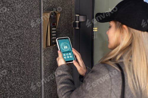 Preview: woman uses smartphone to open the door of his house