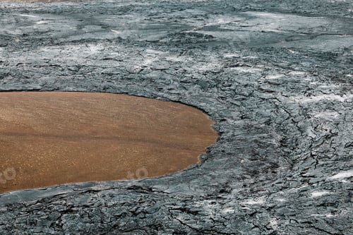 Preview: Cooled lava rocks surrounding a patch of red soil near Geldingadalir volcano in Iceland