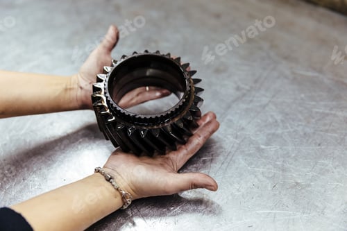 Preview: Woman with a piece of car engine
