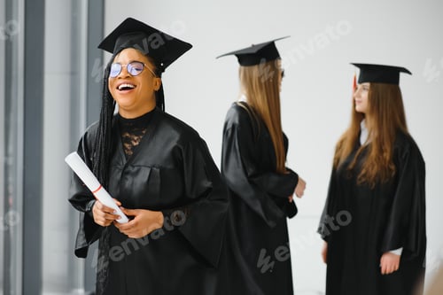 Preview: portrait of multiracial graduates holding diploma