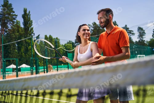 Preview: Woman learning a proper serve stance during the tennis session