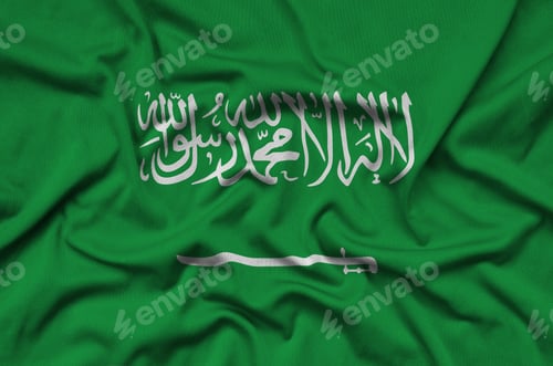 Preview: Saudi Arabia flag is depicted on a sports cloth fabric with many folds. Sport team waving banner