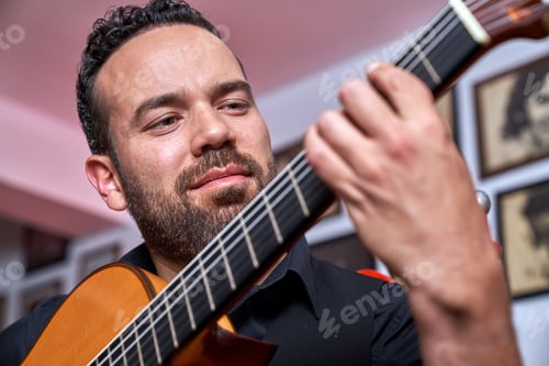 Preview: Flamenco guitarist playing acoustic guitar, hands expertly creating music, sharing Spanish culture