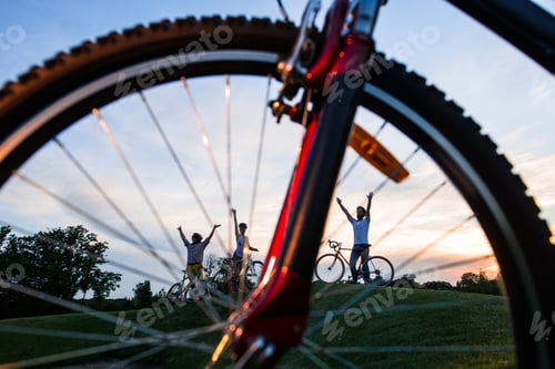 Preview: Young happy cyclists outdoors.