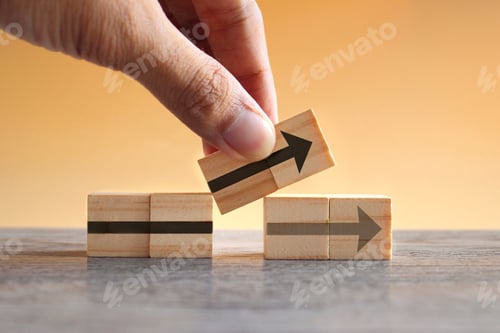 Preview: Hand holding wooden cubes with arrow icon.