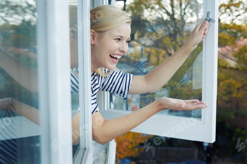 Preview: Young woman leaning out of window
