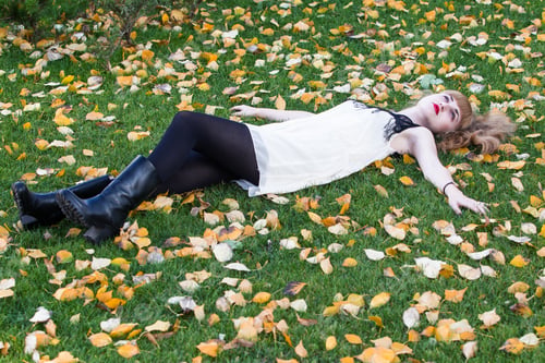 Preview: Red-Haired Girl In A White Dress And Black Stockings Lying On Green Grass