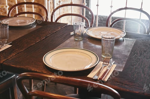 Preview: close-up shot of plates with cutlery and glasses on table at restaurant