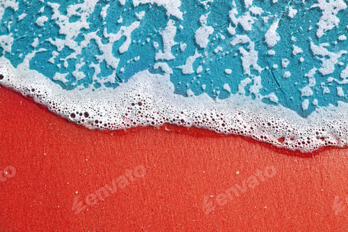 Preview: Soft sea wave with foam on a pink sand beach, text space. sea landscape background
