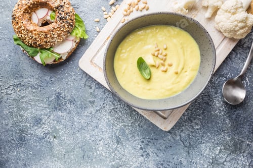 Preview: Bowl of Cauliflower Soup with Toasted Bagel