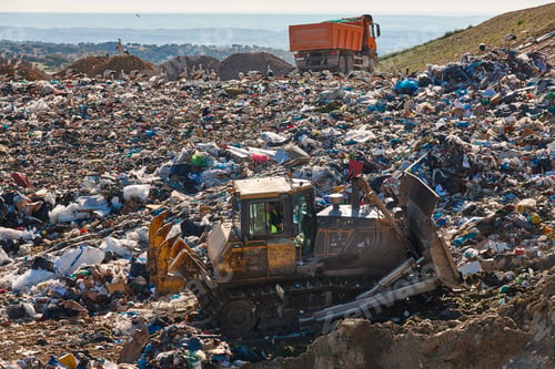 Preview: Heavy machinery shredding garbage in an open air landfill. Pollution