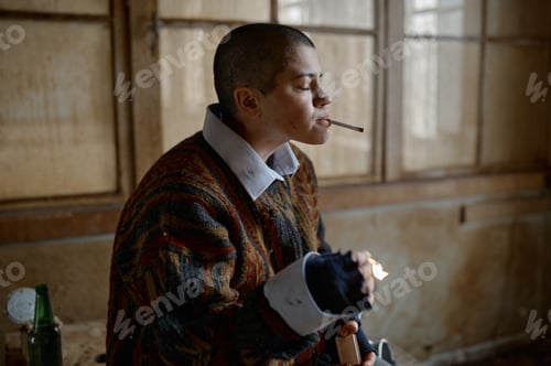 Preview: Portrait of young frustrated homeless woman smoking cigarette