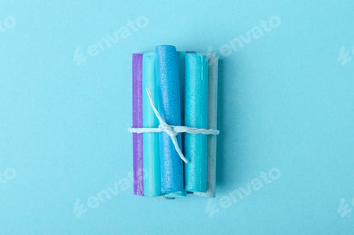 Preview: Several pastel crayons tied with a ribbon on blue pastel paper. Blue palette