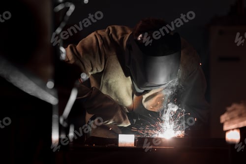 Preview: Front View of Welder in Protection Mask Working With Metal at Factory