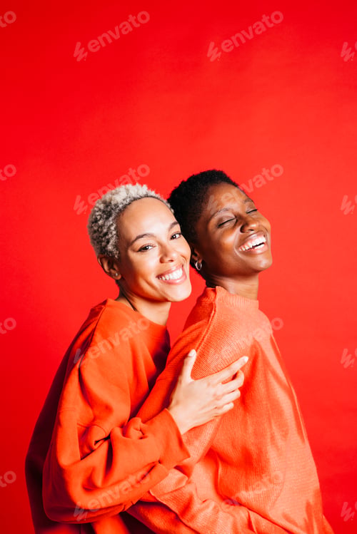 Preview: Two women wearing red clothes in studio