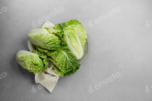 Preview: Fresh ripe Chinese cabbages on light grey table, top view. Space for text