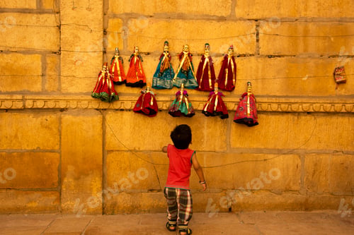 Preview: Kid watching puppet on the street of jaisalmer, India.