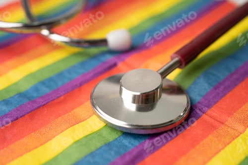 Preview: Red stethoscope on rainbow flag background, symbol of LGBT pride month celebrate annual in June
