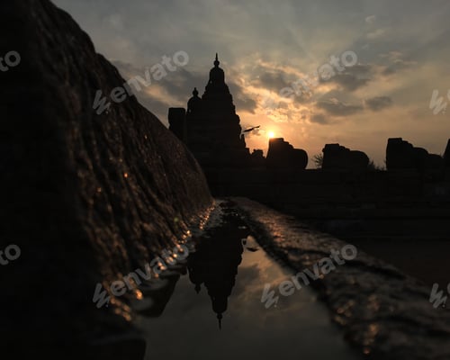 Preview: Tranquil fountain featuring a picturesque backdrop of silhouettes of buildings at sunset