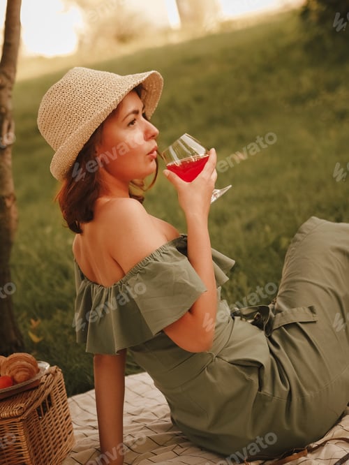 Preview: Woman drinking wine having Picnic at backyard garden
