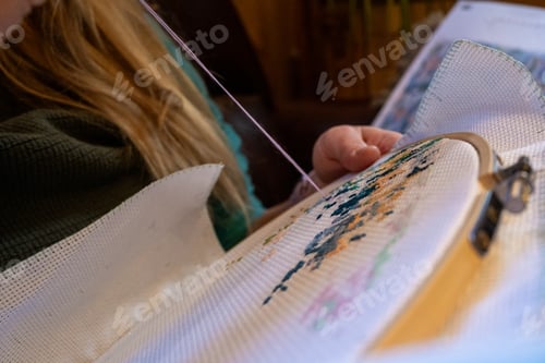 Preview: Woman hands doing cross stitch