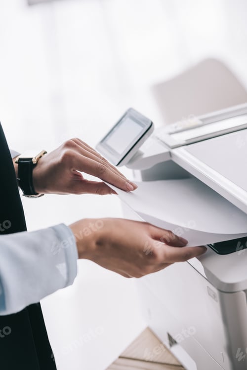 Preview: cropped shot of woman in formal wear using copier